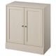 Option: A beige HAVSTA cabinet made of solid pine with a brushed finish, showcasing a simple, rectangular design with two soft-close doors.