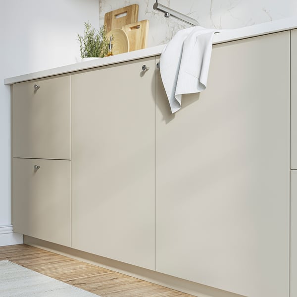 HAVSTORP beige kitchen cabinets with sleek design and ample storage.
