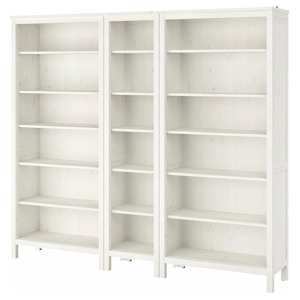 Two white wooden HEMNES bookshelves with adjustable shelves, standing side by side.