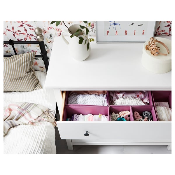 Bedroom with white HEMNES chest, smooth drawers, and wall art. Plants in vase add decor.