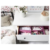 Bedroom with white HEMNES chest, smooth drawers, and wall art. Plants in vase add decor.