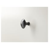 Modern, single black wall-mounted hook. Suitable for coats or towels. Elegant, minimalist design.