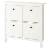 White HEMNES shoe cabinet, four compartments, simplistic design.