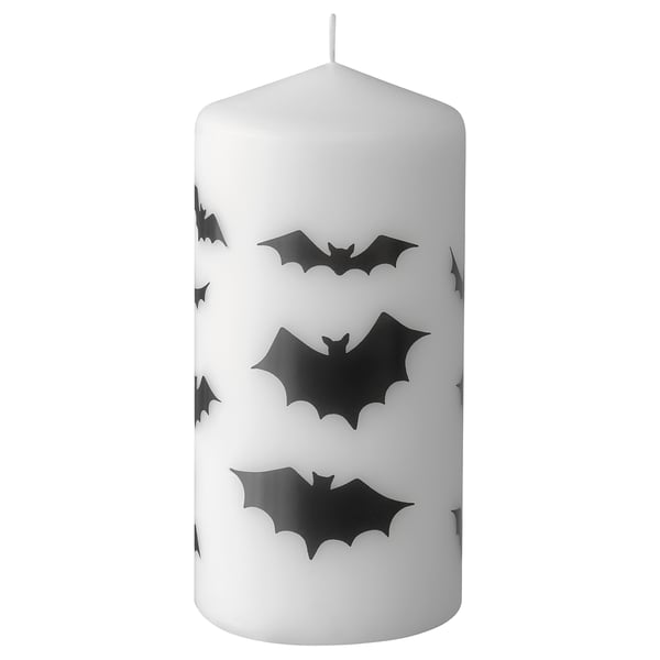 White halloween themed candle with black bat silhouettes, cylindrical shape, cotton wick.
