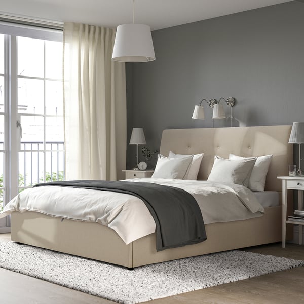 IDANÄS upholstered bed with sloped headboard and storage, cozy bedding, large pendant light.