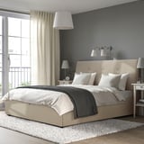 IDANÄS upholstered bed with sloped headboard and storage, cozy bedding, large pendant light.