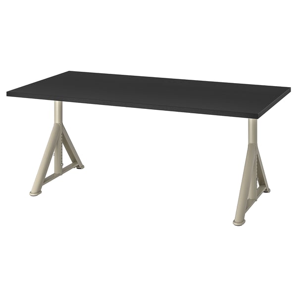 An IKEA IDÅSEN desk with a black top and adjustable silver legs. Its rectangular and has a modern, minimalist design with built-in cable management.