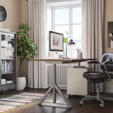 Home office with IDÅSEN desk, chair, and large window with curtains and rug.