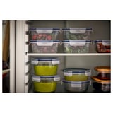 IKEA 365+ food containers, clear with blue lids, square and round shapes, organized in fridge.