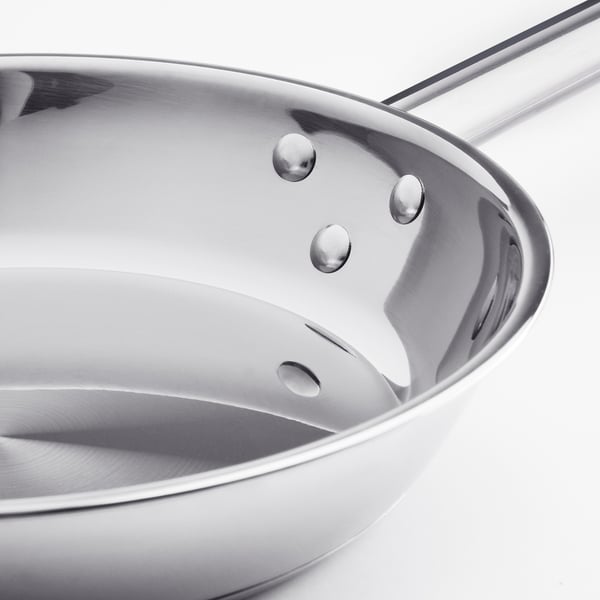 Stainless steel frying pan with durable, even heat distribution, featuring a mirror-like interior and sturdy handle.
