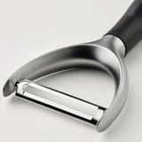 Stainless steel peeler with black handle; ergonomic design, sharp blade.