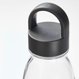Clear plastic bottle with black lid and handle, designed for durability and easy portability. Ideal for water, beverages, and juices.