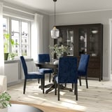 Dining area with INGATORP table, blue upholstered chairs, wooden floor, large window, and dark cabinet.