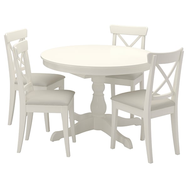 White round extendable dining table & 4 matching chairs, sleek design, solid wood, easy-clean surfaces.