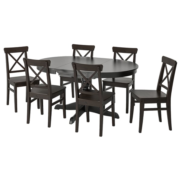 Dark wood round dining table with 6 matching chairs, all featuring x-back design. Ideal for small spaces.