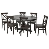 Dark wood round dining table with 6 matching chairs, all featuring x-back design. Ideal for small spaces.