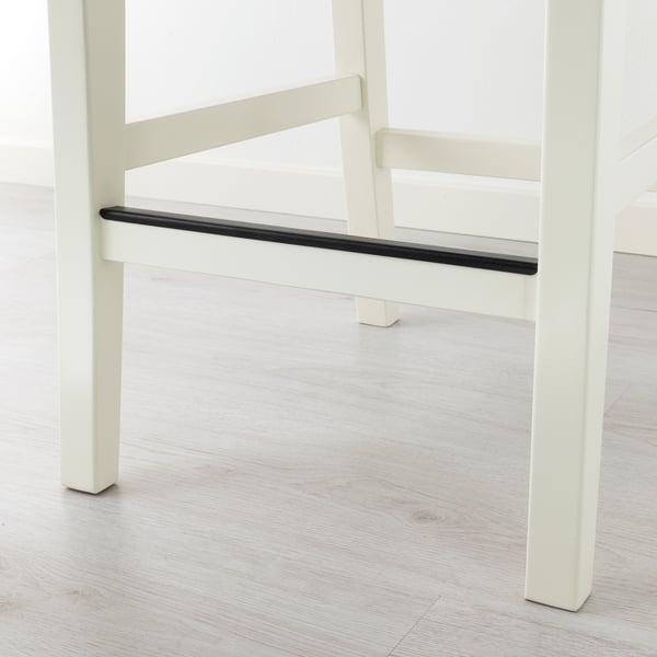 Modern white chair with sleek design. Solid wood construction for durability. Footrest for comfortable seating.