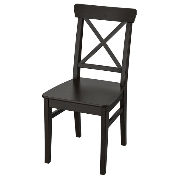 A black INGOLF chair with a high back, sturdy pine wood construction, and a woven seat. Its sleek, dark design adds a modern touch.