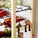 IVAR wine rack holding bottles on metal hooks.
