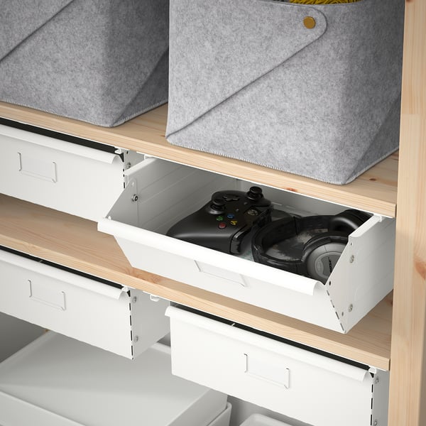 Open IVAR drawer showing a gaming controller and headphones, ideal for storing tech accessories.