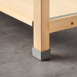Wooden IVAR furniture leg with metal cap, protecting from moisture, ensuring stability.