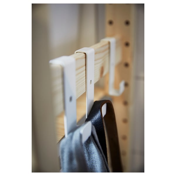 This image an IVAR white metal hook holding a dark object, showcasing a practical and minimalist design.