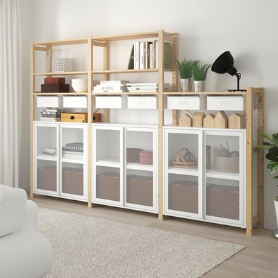IVAR storage combo: light wood shelves, white mesh cabinet. Bright living room space.