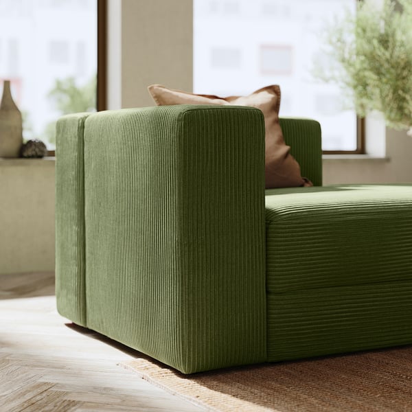 Modern green JÄTTEBO sofa, angular design, textured corduroy, cozy and stylish.
