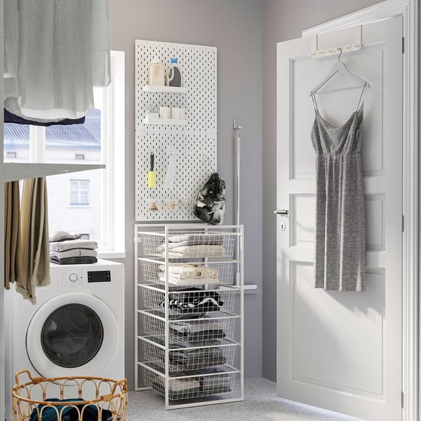 White JONAXEL storage rack with baskets for laundry room.