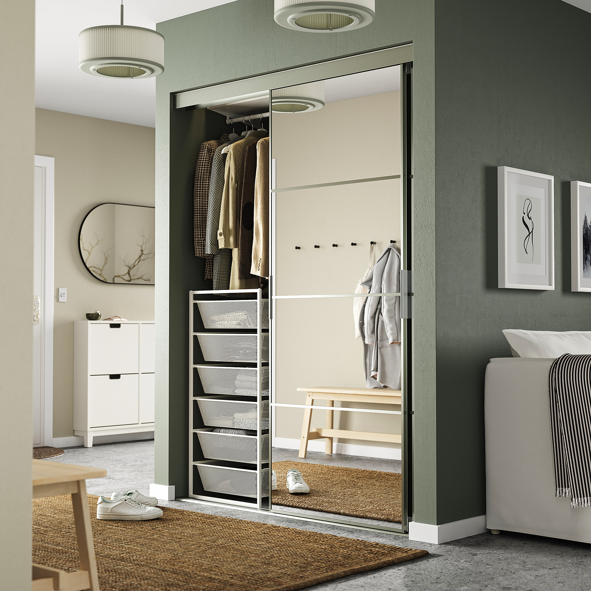 Modern bedroom with green wall, built-in JONAXEL storage, mirror, shelves, hanging rod, and pendant lights.