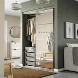 JONAXEL steel storage with mirror door in room, organizing clothes neatly.