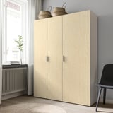 Light wood cabinet with two doors, two woven baskets on top, and a plant beside it.