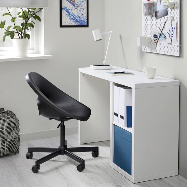 Compact KALLAX white desk with blue accents; black rolling chair, modern minimalist setup.