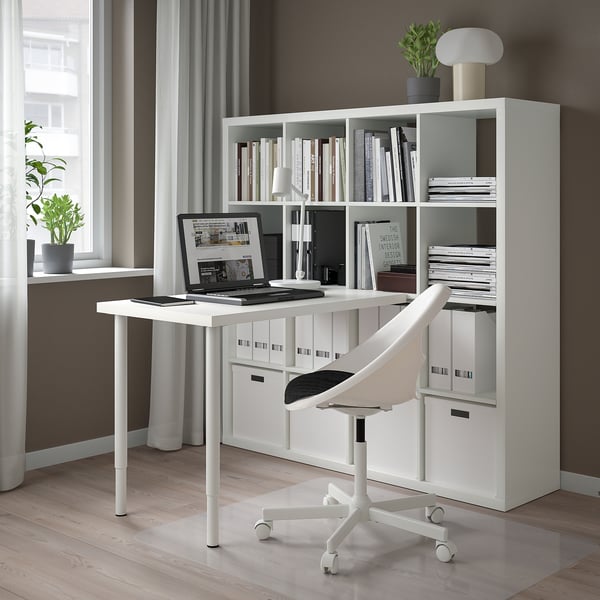 Modern KALLAX desk setup with laptop, books, lamp, and chair. Minimalistic, spacious, and organized.