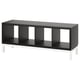 Option: Black KALLAX shelving unit with four open cubbies, standing on white metal legs, modern design.