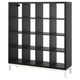Option: The KALLAX shelf is a black, square unit with multiple compartments, supported by white legs. Its design offers versatile storage with clean lines.