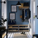 Hallway with blue KALLSÖ bench, shoe storage, maps, and pendant light.