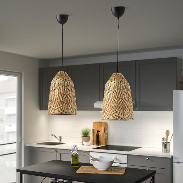 Modern kitchen with two KAPPELAND pendant lamps, providing warm, decorative light. Herringbone rattan shades enhance atmosphere.