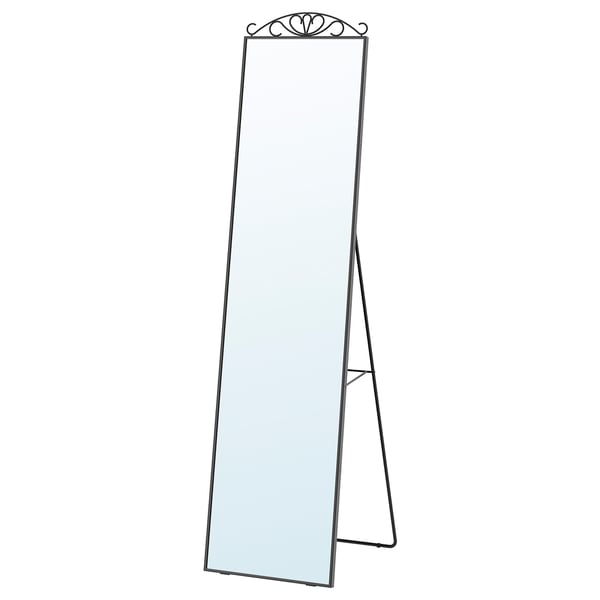 KARMSUND full-length mirror with optional decorative top, stands on a black metal frame with an elegant finish.