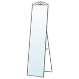 KARMSUND full-length mirror with optional decorative top, stands on a black metal frame with an elegant finish.