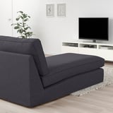 Modern living room with KIVIK gray chaise longue, tv, plant, and frames. Chic and cozy design.