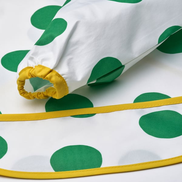 Soft, patterned bib with long sleeves and front pocket, designed for comfort and easy cleaning.