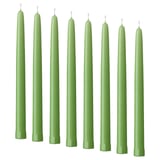 Eight green KLOKHET candles in a row, tall and straight, uniform color and shape, made of stearin.