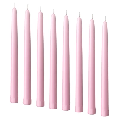 Nine pale pink KLOKHET candles in a row, cylindrical shape, made of stearin.