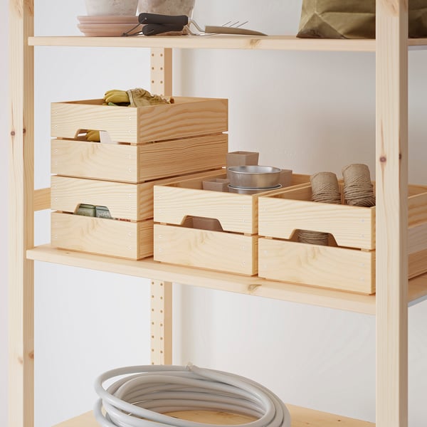 KNAGGLIG: light wooden storage boxes, neatly stacked, containing different items. Ideal for organizing, durable, and versatile for various spaces.