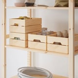KNAGGLIG: light wooden storage boxes, neatly stacked, containing different items. Ideal for organizing, durable, and versatile for various spaces.