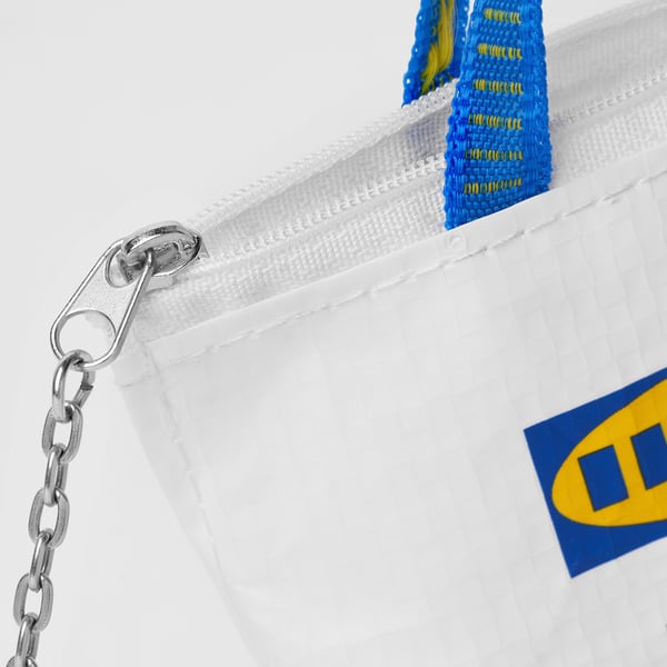 Small white bag with blue and yellow zipper, strong metal chain, and brand logo.