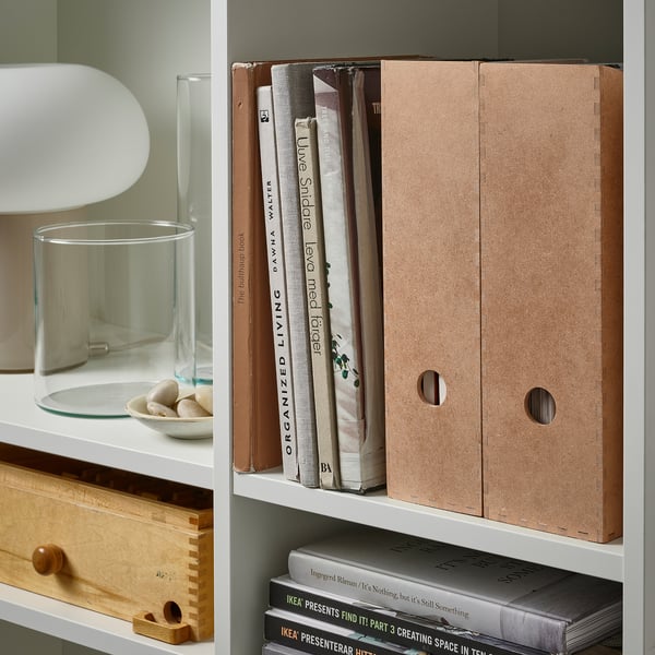 Bookshelf with KNUFF magazine files organizing papers and books.