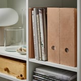 Bookshelf with KNUFF magazine files organizing papers and books.