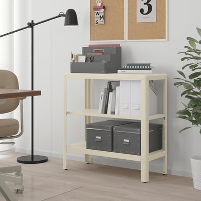 Ikea KOLBJÖRN white shelf with books, supplies, and plant.